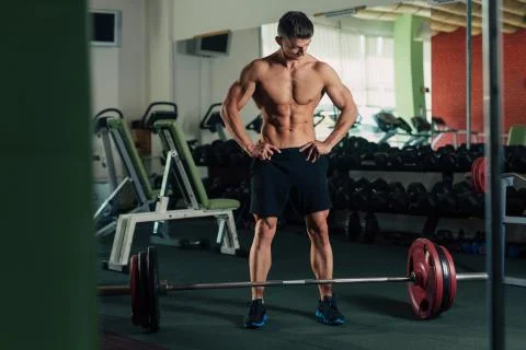 Young fit man resting between exercises in the gym Stock Photos