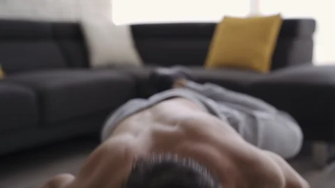 Young Fit Man Working Out at Home Spiderman Pushups Stock Footage 117469191