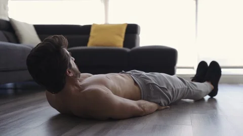 Young Fit Man Working Out at Home Ab Scissors Stock Footage 117517481