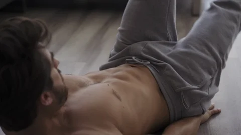 Young Fit Man Working Out at Home Ab Scissors Stock Footage 117520737
