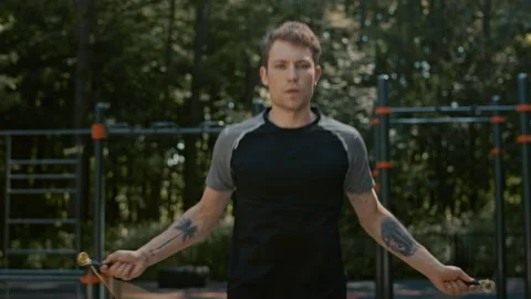 Young fit man workout in park with jump rope Stock Footage 168730974