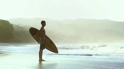 Young fit surfer man guy at beach with surfboard, summer surf adventure Stock Footage 108565388
