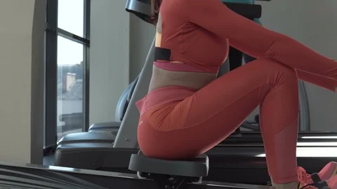 Young fitness woman make exercise on rowing machine in gym Stock Footage