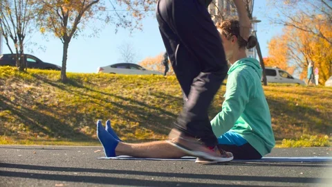 Young flexible man doing choreography exercises on the sports field. Stock-Footage 96588797