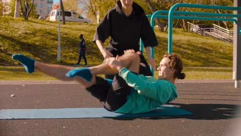 Young flexible man doing choreography exercises on the sports field. 動画素材 96590710