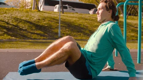 Young flexible man doing exercises for the press Stock Footage 96590375