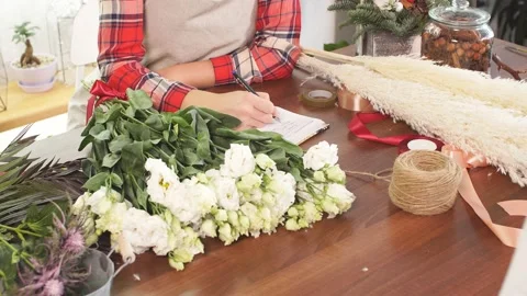 Young florist lady with notebook Stock Footage 122740346