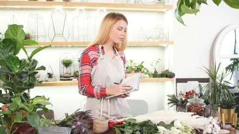 Young florist lady with notebook Stock Footage 123434220