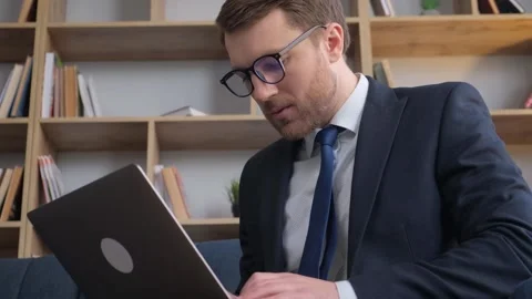 Young focused financial worker software developer working on laptop. Stock Footage 243926186