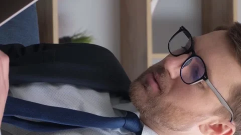 Young focused financial worker software developer working on laptop. Vertical Stock Footage 250283813