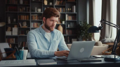 Young focused man working at laptop computer Stock Footage 260925070
