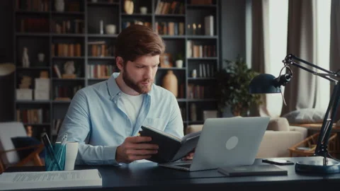 Young focused man working at laptop computer Stock Footage 260927034
