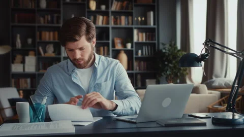 Young focused man working at laptop computer Stock Footage 260927864