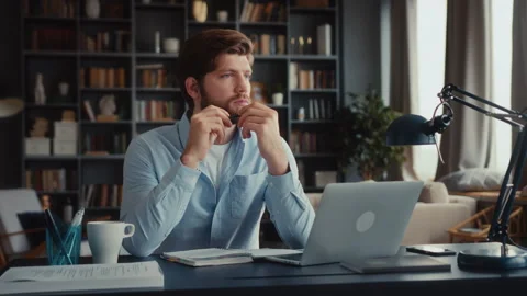 Young focused man working at laptop computer Stock Footage 260928691
