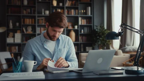 Young focused man working at laptop computer Stock Footage 260930281