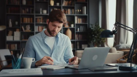 Young focused man working at laptop computer Stock Footage 260930762