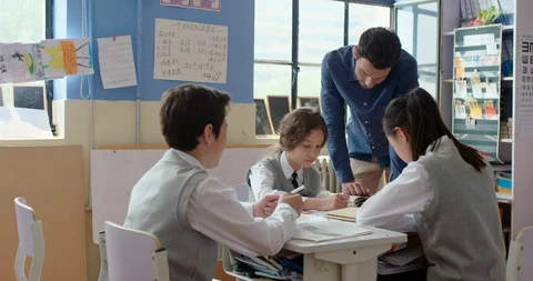 Young foreign teacher helping students in class,4K Stock Footage 120898093