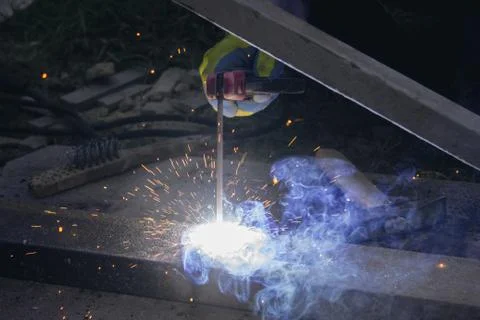 Young foreman doing electrical welding Stock Photos