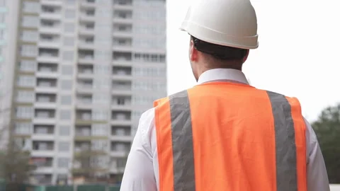 Young foreman goes to the construction site to manage a project Stock Footage 124646154
