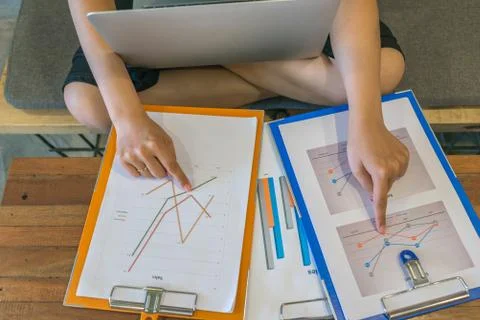 Young freelancer comparing financial documents Stock-Fotos