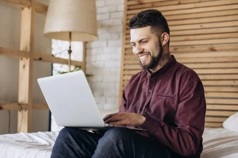 Young freelancer man working at computer at home Stock Photos