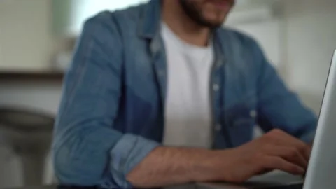 Young freelancer man working on laptop, developing project while working at home Stock Footage 155332072