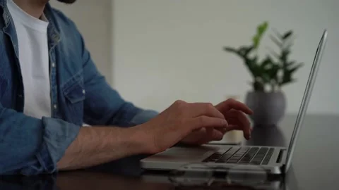 Young freelancer man working on laptop, developing project while working at home Stock Footage 155332073