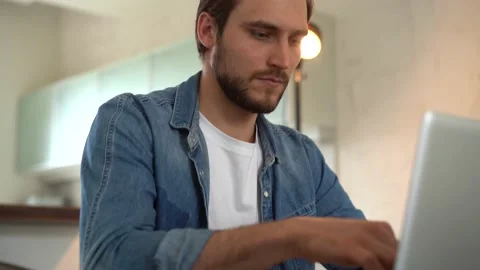 Young freelancer man working on laptop, developing project while working at home Stock Footage 155332083