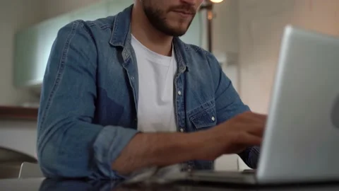 Young freelancer man working on laptop, developing project while working at home Stock Footage 155332084