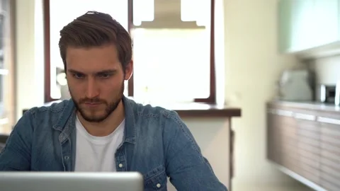 Young freelancer man working on laptop, developing project while working at home Stock Footage 155332094
