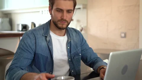 Young freelancer man working on laptop, developing project while working at home Stock Footage 155332097