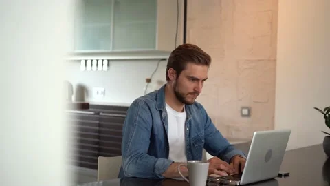Young freelancer man working on laptop, developing project while working at home Stock Footage 155332110