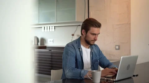 Young freelancer man working on laptop, developing project while working at home Stock Footage 155332111