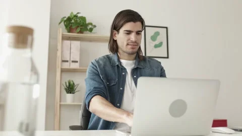 Young freelancer man working on laptop computer from home office Stock Footage 174312890
