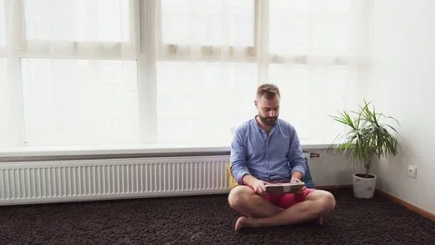 Young freelancer man working on a tablet computer at home Stock Footage 82422042