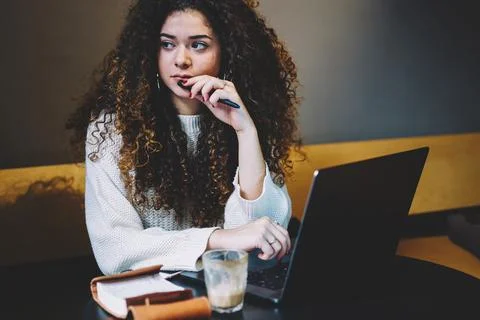 Young freelancer with netbook computer feeling pondering in coffee shop Stock Photos