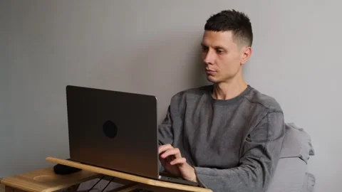Young freelancer opening laptop in bed and starting work at home, remote work Stock Footage 314743930