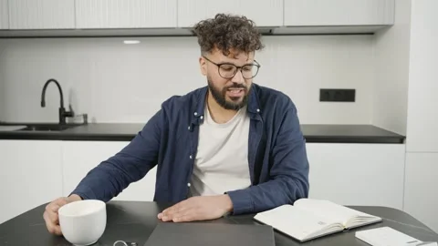 Young freelancer planning day while drinking coffee Stock Footage 345128945
