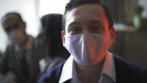 Young freelancer take of protective mask and make a funny face while works in Stock Footage 130602996