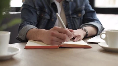 Young freelancer using notebook in the cafe for his work or plans Stock Footage 74855470