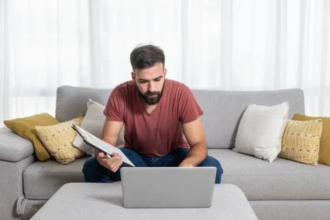 Young freelancer worker man typing the new business contract and plan Stock Photos