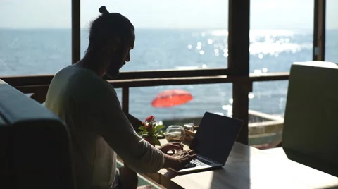 Young freelancer working on the background of the sea Stock Footage 67175153