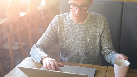 Young freelancer working in the cafe on laptop Stock Footage 88875196