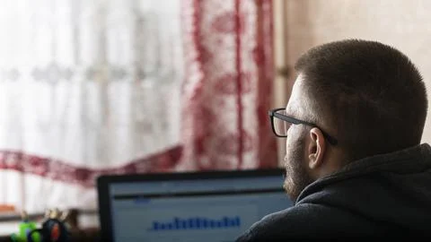 Young freelancer working at a computer at home Stock Photos