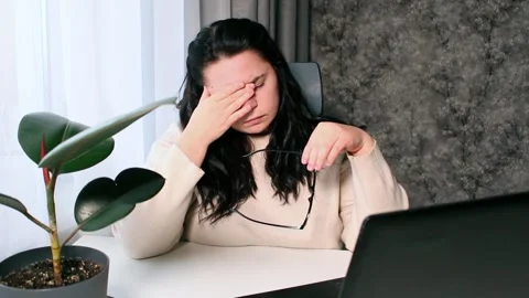 Young freelancer working from home feeling tired after working whole day Stock Footage 308014929