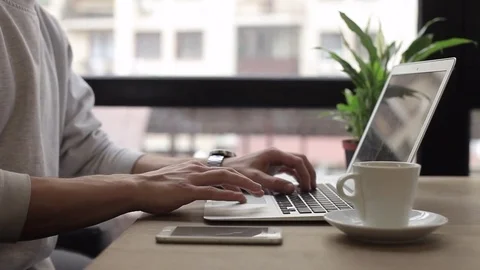 Young freelancer working on a macbook in cafe Stock Footage 74855383