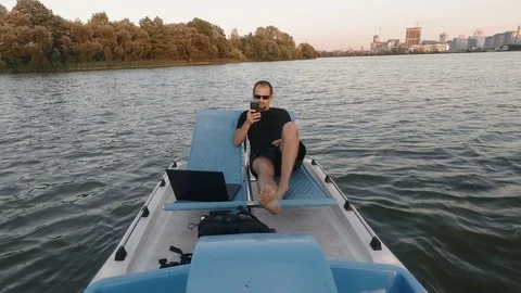 Young freelancer works on the computer on a boat. Remote Business. passive 스톡 동영상 99539652