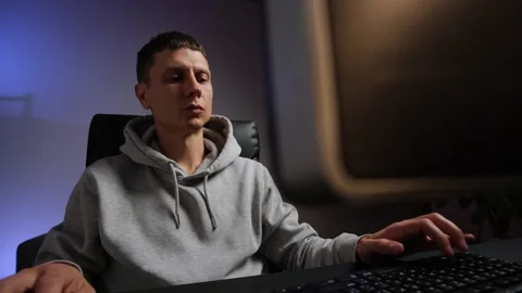 Young freelancer works at computer in home office with cozy evening atmosphere Stock Footage 315664465