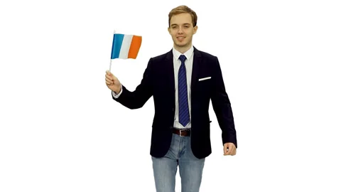 Young friendly man in suit jacket and jeans walks with waving flag of France Stock-Footage 123152009