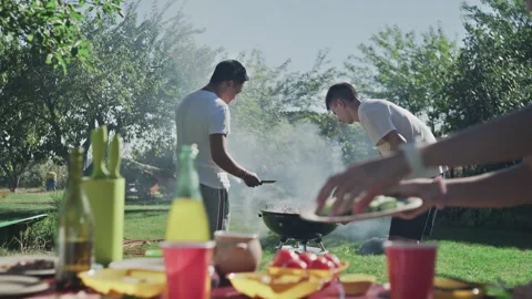 Young friends are preparing bbq party outdoors Video stock 140719943